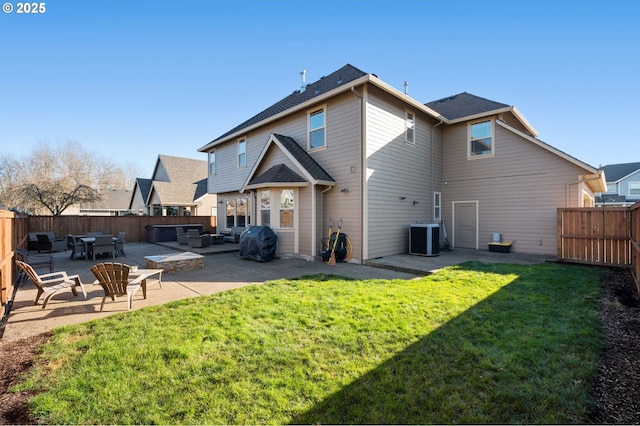 rear view of property with a fenced backyard, a lawn, a patio, and central AC unit