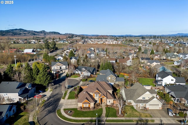 birds eye view of property with a mountain view and a residential view