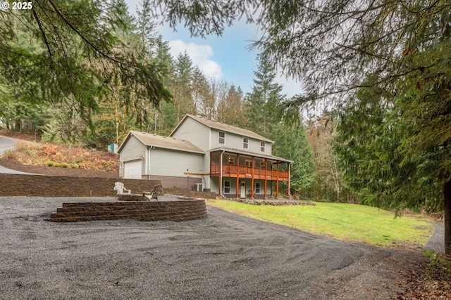 view of front of house with a garage and a front lawn