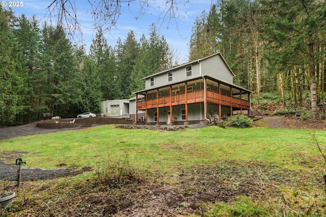 rear view of house featuring a yard