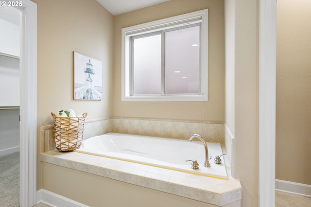 bathroom with tiled tub