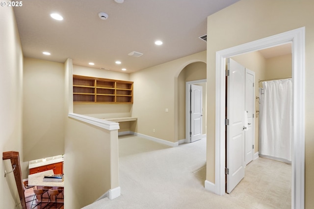 corridor with light colored carpet