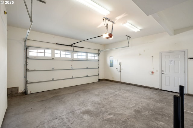 garage with a garage door opener and electric panel