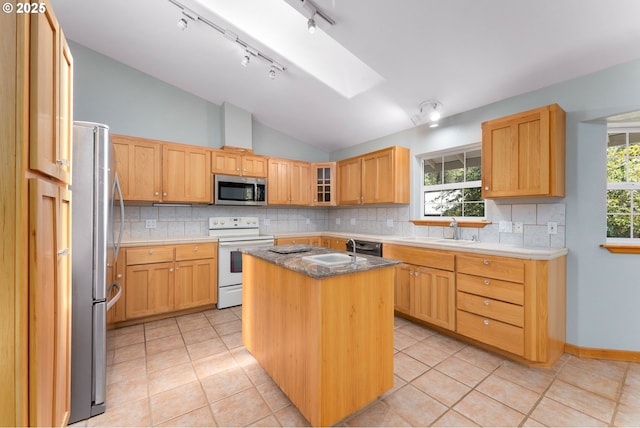 kitchen featuring tasteful backsplash, vaulted ceiling, and stainless steel appliances