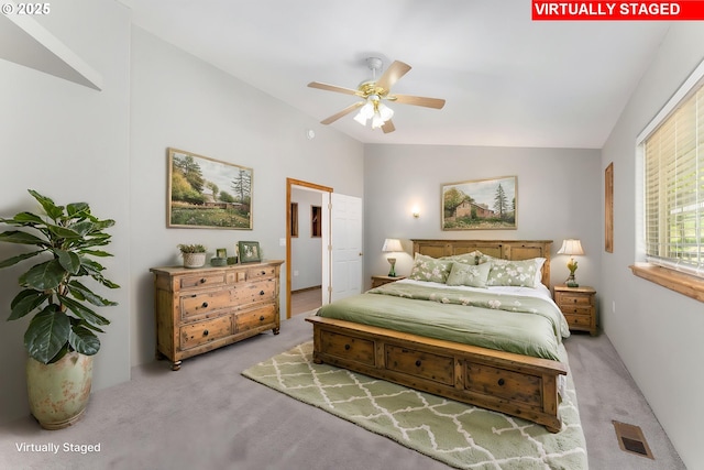 bedroom with visible vents, carpet flooring, and lofted ceiling