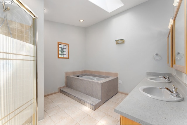 full bath with a skylight, a sink, tile patterned floors, and a stall shower