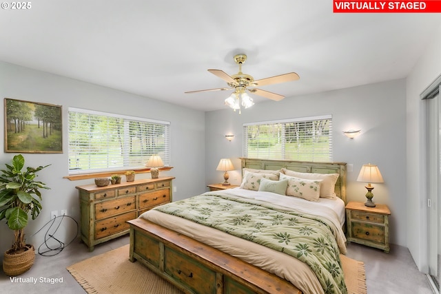 bedroom with a ceiling fan and multiple windows
