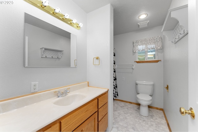 full bathroom featuring vanity, visible vents, toilet, baseboards, and tile patterned floors