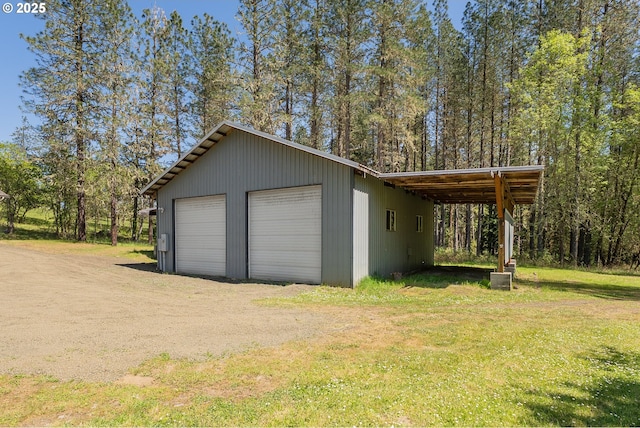 garage with a detached garage and driveway