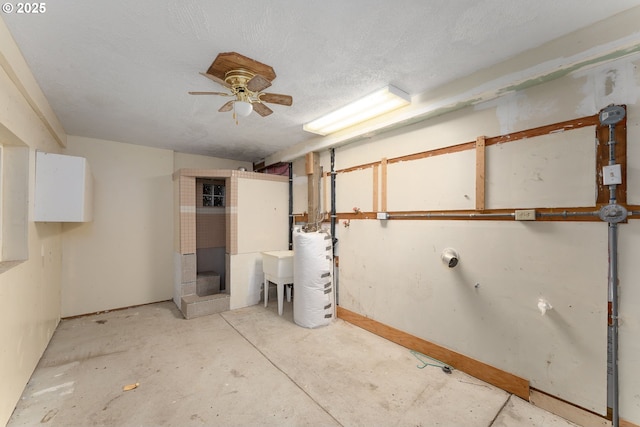 below grade area featuring water heater and ceiling fan