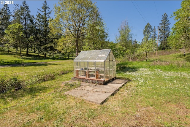 view of greenhouse with a yard