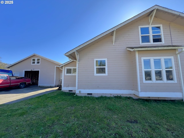 view of property exterior featuring a garage, a yard, and crawl space