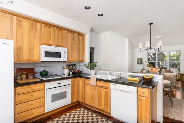 884 NE 73rd Ave, Hillsboro, OR 97124 - kitchen featuring white appliances, a peninsula, backsplash, a chandelier, and dark countertops
