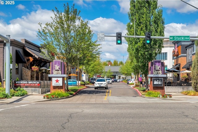 884 NE 73rd Ave, Hillsboro, OR 97124 - view of asphalt road featuring curbs, traffic lights, sidewalks, traffic signs, and street lighting