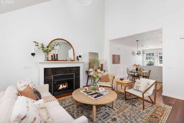 884 NE 73rd Ave, Hillsboro, OR 97124 - living area featuring wood finished floors, a chandelier, a fireplace, and a towering ceiling
