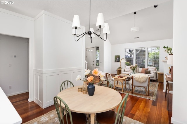 884 NE 73rd Ave, Hillsboro, OR 97124 - dining space with dark wood finished floors, plenty of natural light, vaulted ceiling, and a chandelier