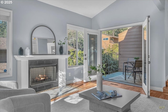 living room with lofted ceiling and light wood-type flooring