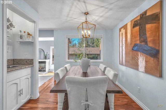 dining space featuring an inviting chandelier and light wood-type flooring