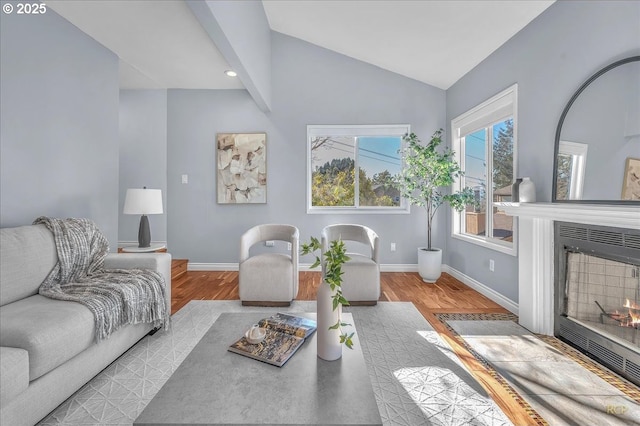 living room featuring vaulted ceiling and light hardwood / wood-style floors