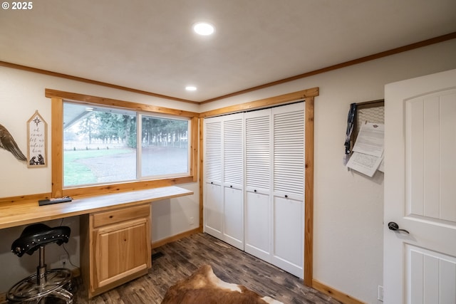 office with ornamental molding, dark hardwood / wood-style floors, and built in desk