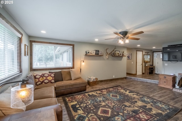 living room featuring wood-type flooring and ceiling fan