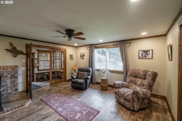 living area with wood-type flooring, crown molding, and french doors