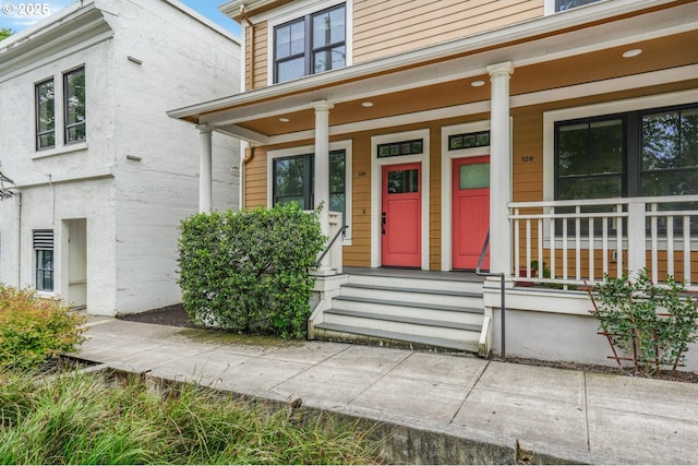 view of exterior entry with a porch