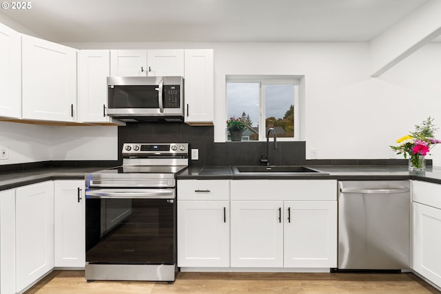 kitchen featuring white cabinetry, appliances with stainless steel finishes, and sink