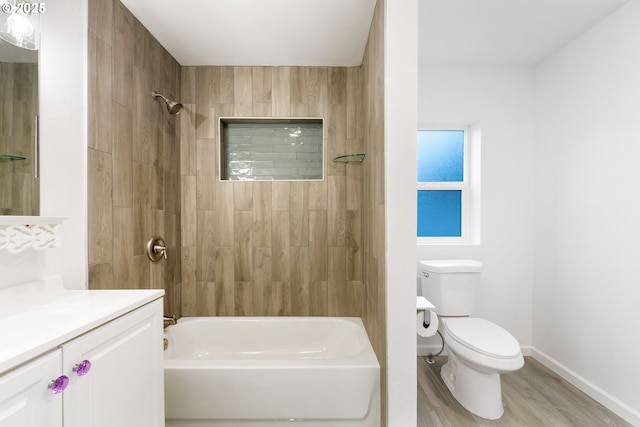 full bathroom featuring vanity, tiled shower / bath combo, wood-type flooring, and toilet