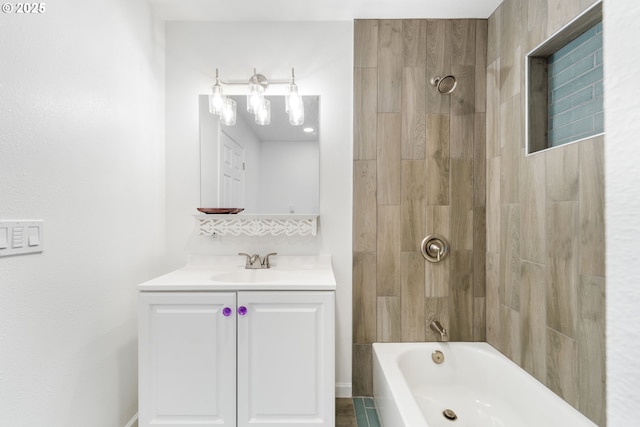 bathroom featuring vanity and tiled shower / bath