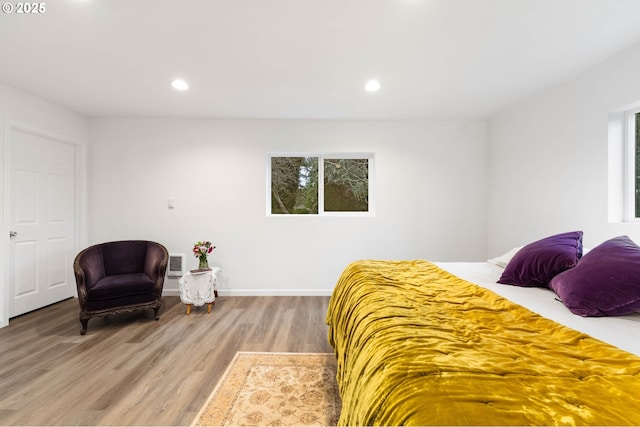 bedroom featuring hardwood / wood-style floors and multiple windows