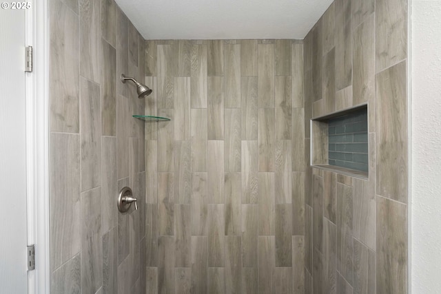 bathroom with tiled shower