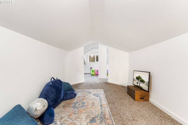 bedroom with vaulted ceiling and light colored carpet