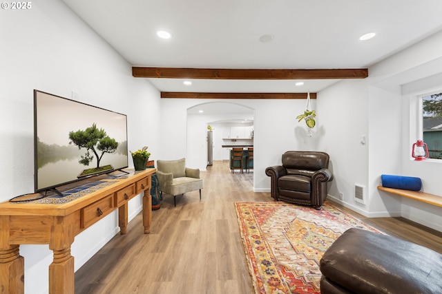 living room with hardwood / wood-style floors and beam ceiling