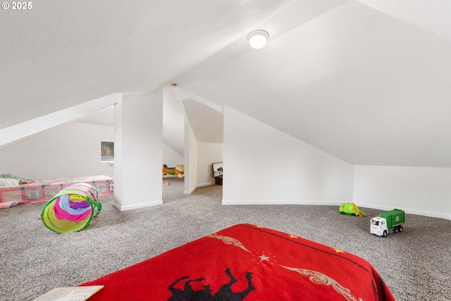 bedroom featuring vaulted ceiling, carpet, and a textured ceiling