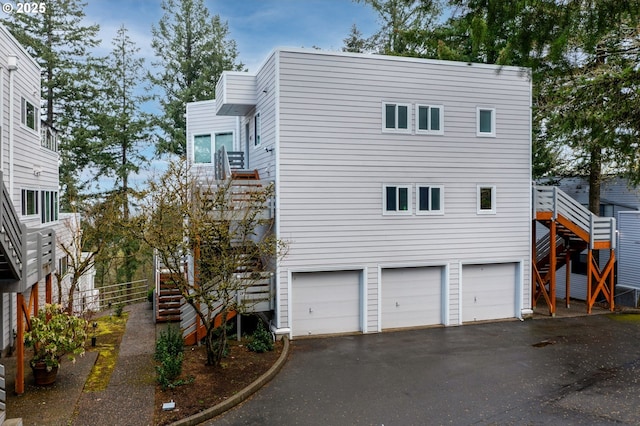 48 Eagle Crest Dr Unit 4C, Lake Oswego, OR 97035 - view of side of home with stairway, asphalt driveway, and an attached garage