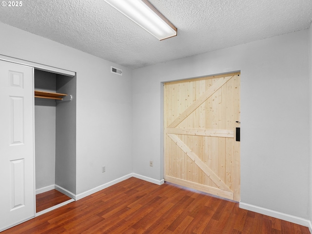 3329 NE 162nd Ave, Portland, OR 97230 - unfurnished bedroom featuring wood finished floors, a textured ceiling, and a closet