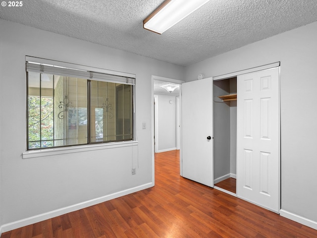 3329 NE 162nd Ave, Portland, OR 97230 - unfurnished bedroom with wood finished floors, a textured ceiling, and a closet