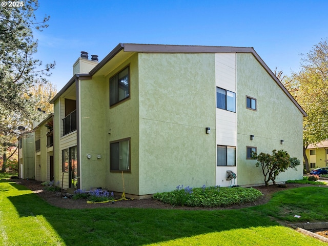 3329 NE 162nd Ave, Portland, OR 97230 - view of property exterior featuring a lawn, stucco siding, and a chimney