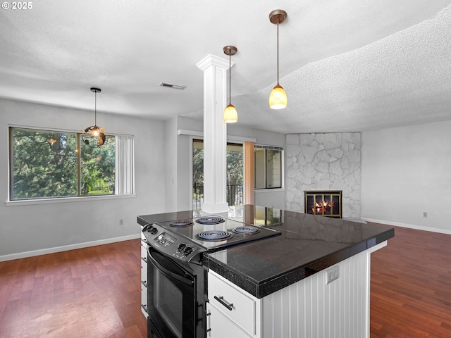 3329 NE 162nd Ave, Portland, OR 97230 - kitchen with black electric range, dark countertops, open floor plan, dark wood-style flooring, and a textured ceiling