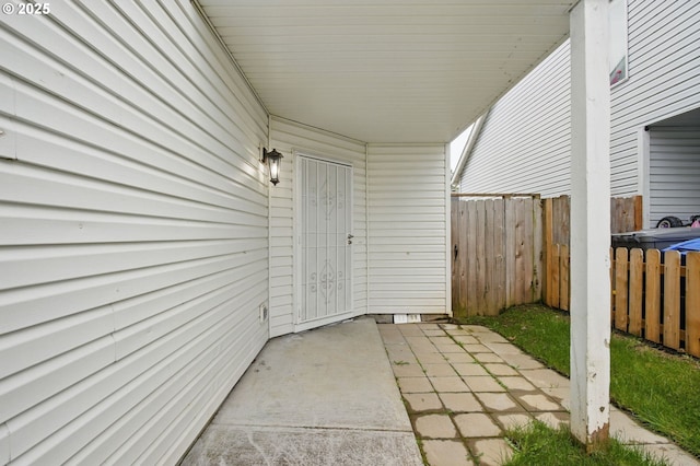 property entrance featuring a patio area and fence