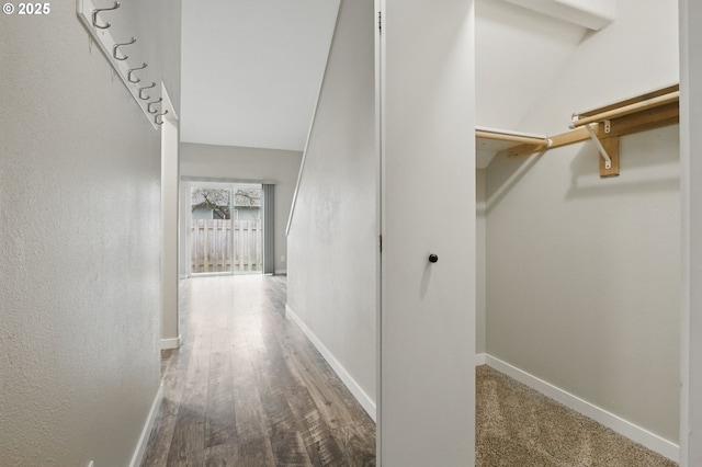 hall with wood finished floors and baseboards