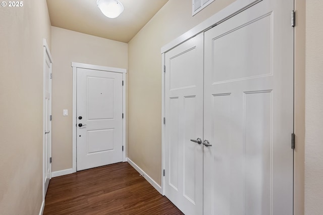 hallway with dark hardwood / wood-style flooring