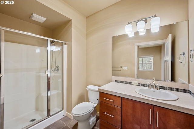 bathroom featuring tile patterned flooring, toilet, an enclosed shower, and vanity