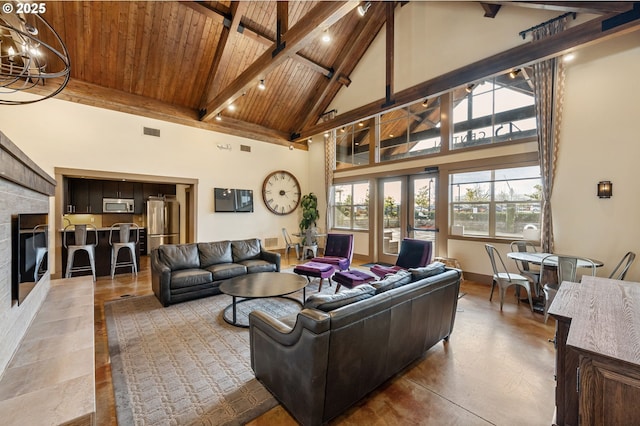 living room with wood ceiling, concrete flooring, high vaulted ceiling, beamed ceiling, and a chandelier