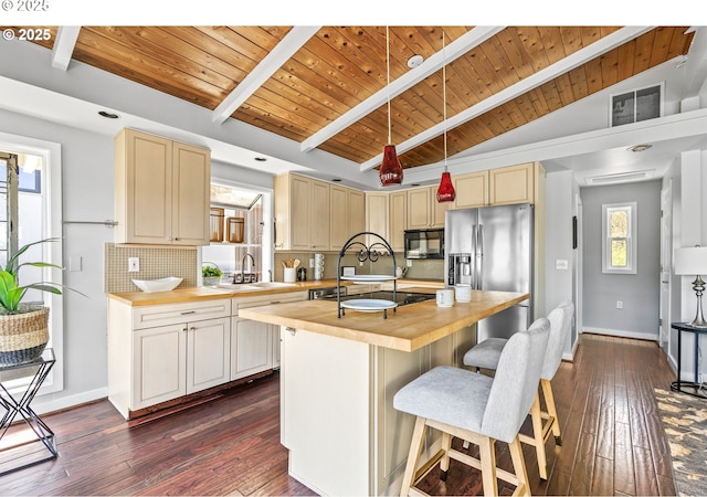 7720 SW Macadam Ave Unit 9, Portland, OR 97219 - kitchen with butcher block countertops, black microwave, a sink, wood ceiling, and backsplash