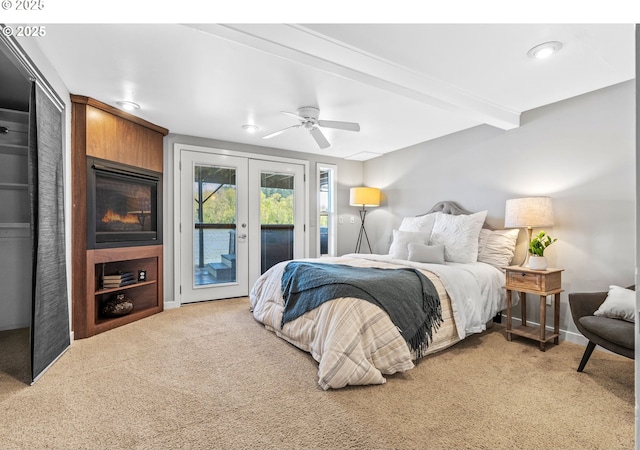 7720 SW Macadam Ave Unit 9, Portland, OR 97219 - bedroom with french doors, light carpet, access to outside, beam ceiling, and baseboards