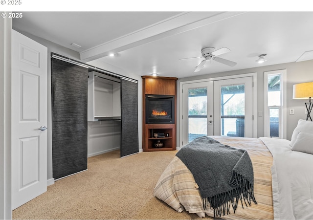 7720 SW Macadam Ave Unit 9, Portland, OR 97219 - carpeted bedroom featuring french doors, access to exterior, multiple windows, and baseboards