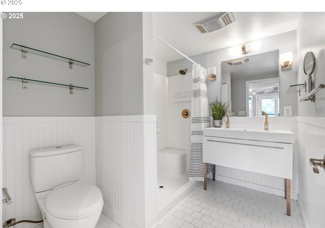7720 SW Macadam Ave Unit 9, Portland, OR 97219 - bathroom with a wainscoted wall, a shower with curtain, vanity, toilet, and tile patterned flooring