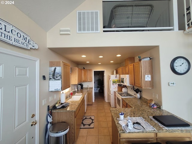 18699 NE Marine Dr Unit C-7, Gresham, OR 97230 - kitchen featuring white appliances, light tile patterned floors, a sink, high vaulted ceiling, and light stone countertops
